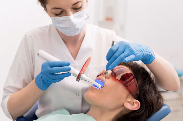 a lady is having dental filling treatment