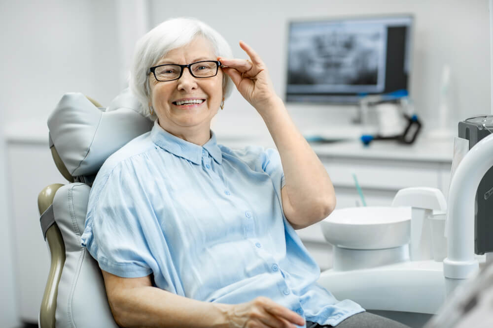 a old lady is smiling after getting dental treatment